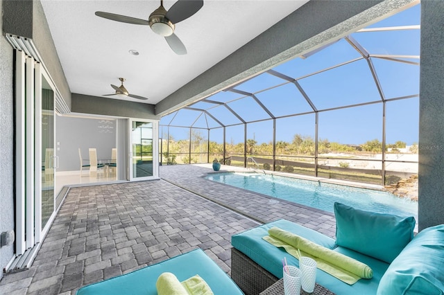 14344 Amestoy Ave, Port Charlotte, FL 33981 - outdoor pool featuring ceiling fan, glass enclosure, a patio, and an outdoor hangout area