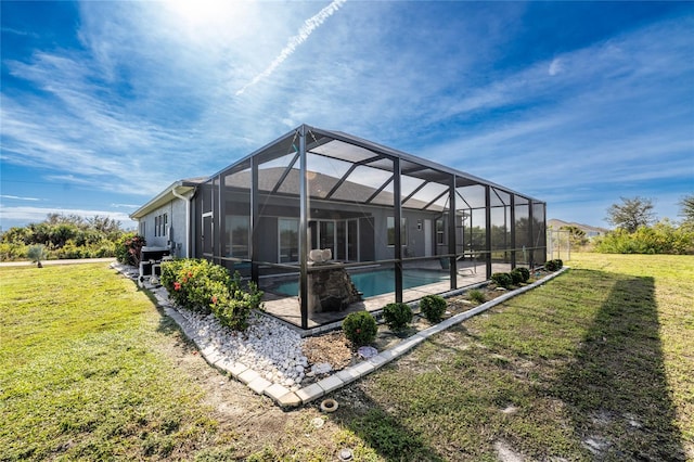 back of property with a yard, a lanai, and a patio area