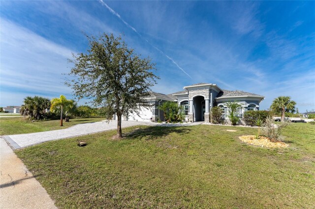 14344 Amestoy Ave, Port Charlotte, FL 33981 - mediterranean / spanish-style house featuring a front yard and curved driveway