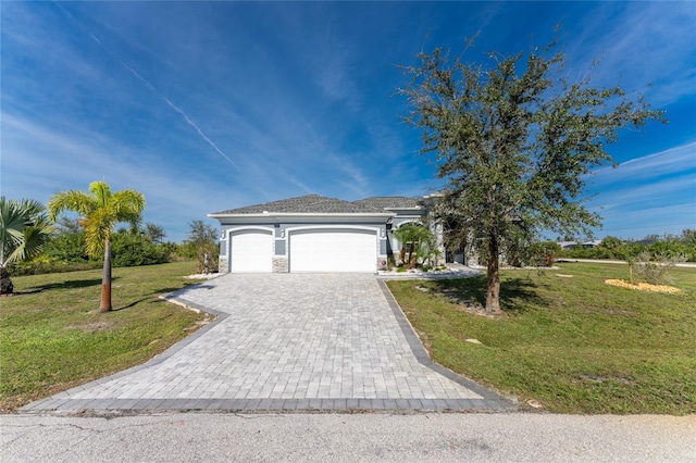 14344 Amestoy Ave, Port Charlotte, FL 33981 - view of front of house with a front lawn, stone siding, decorative driveway, and an attached garage