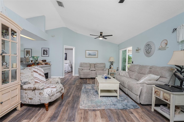 living room featuring vaulted ceiling, ceiling fan, and dark hardwood / wood-style floors