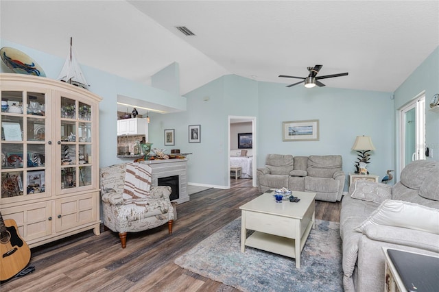 living room featuring vaulted ceiling, ceiling fan, and dark hardwood / wood-style floors