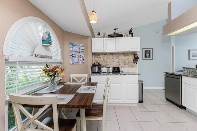 kitchen with decorative light fixtures, backsplash, white cabinetry, dishwasher, and vaulted ceiling