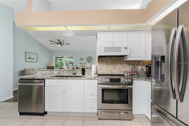 13511 Foresman Blvd, Port Charlotte, FL 33981 - kitchen featuring ceiling fan, a peninsula, appliances with stainless steel finishes, a sink, and backsplash