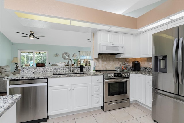 kitchen featuring decorative backsplash, white cabinetry, appliances with stainless steel finishes, and sink