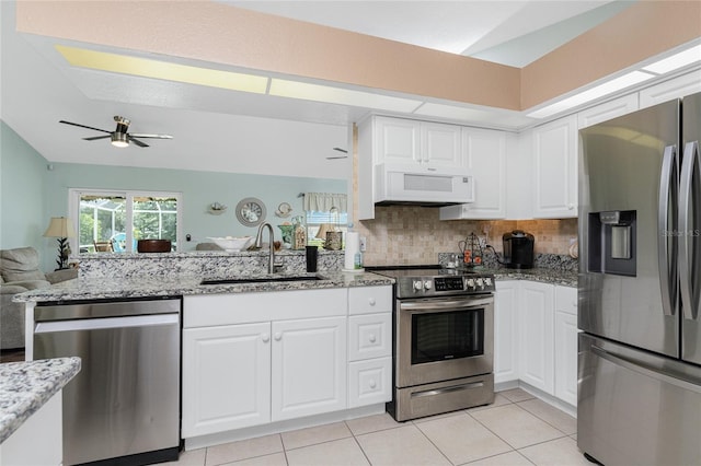 13511 Foresman Blvd, Port Charlotte, FL 33981 - kitchen with a sink, ceiling fan, appliances with stainless steel finishes, backsplash, and light stone counters
