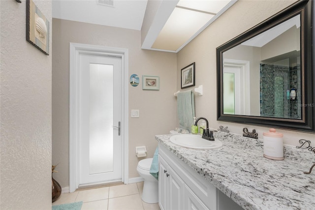 bathroom with a shower with shower curtain, tile patterned floors, vanity, and toilet