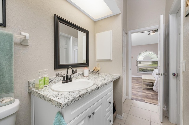 bathroom with wood-type flooring, vanity, and toilet