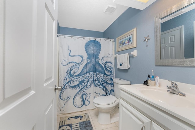 bathroom with vanity, toilet, and tile patterned floors