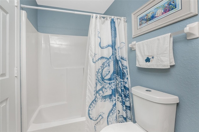 bathroom featuring shower / bath combination with curtain and toilet