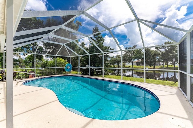 view of pool with a water view, a patio area, and glass enclosure