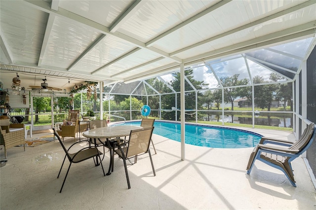 view of swimming pool featuring ceiling fan, glass enclosure, and a patio area