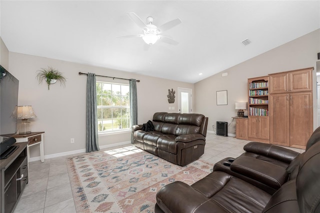 tiled living room featuring ceiling fan and vaulted ceiling