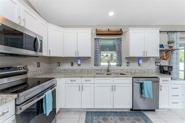 kitchen with sink, appliances with stainless steel finishes, white cabinets, and plenty of natural light