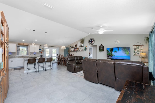 living room featuring sink, vaulted ceiling, and ceiling fan