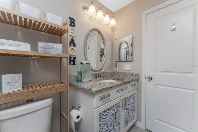 bathroom featuring toilet and vanity