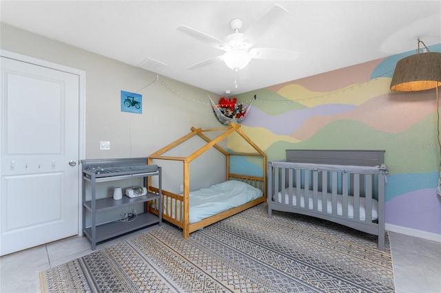 tiled bedroom with ceiling fan