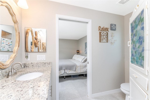 bathroom featuring vanity, toilet, and tile patterned floors