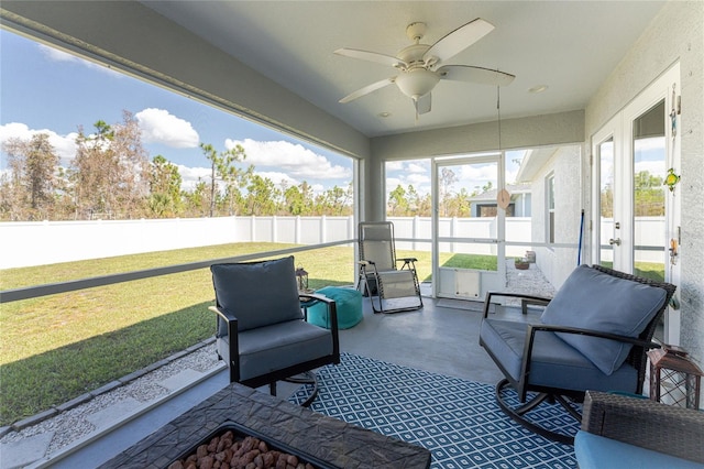 sunroom featuring ceiling fan