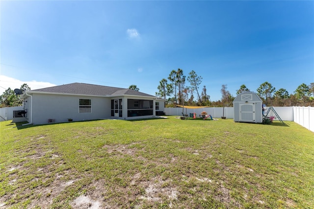 view of yard featuring a sunroom and a storage unit