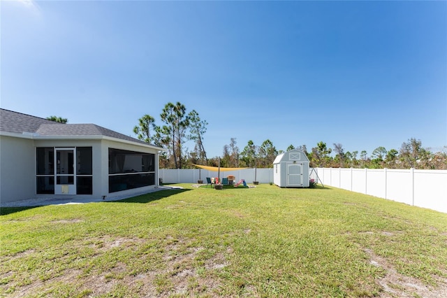 view of yard featuring a storage unit and a sunroom