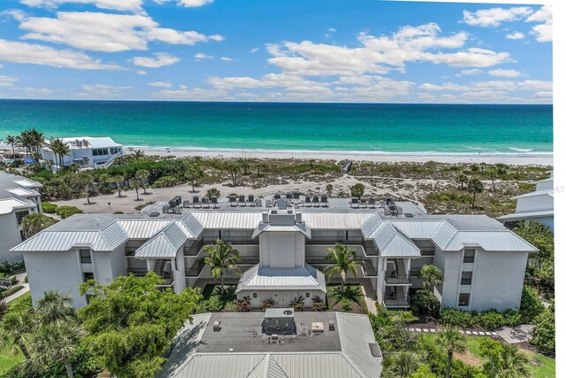 drone / aerial view featuring a view of the beach and a water view