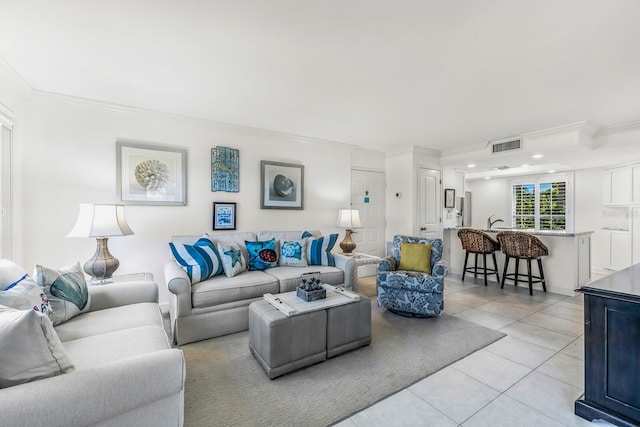 living room featuring ornamental molding and light tile patterned floors