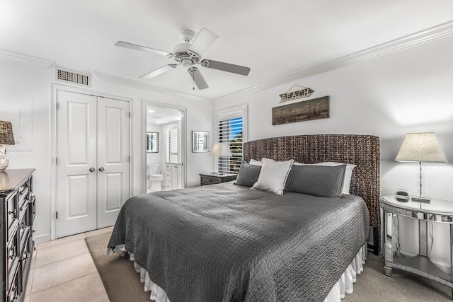 tiled bedroom with crown molding, a closet, connected bathroom, and ceiling fan