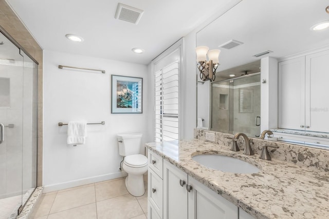 bathroom with toilet, tile patterned flooring, vanity, and a shower with door