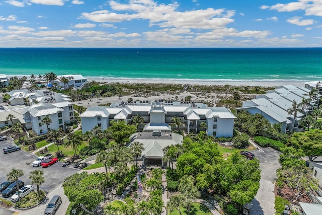 bird's eye view featuring a water view and a beach view