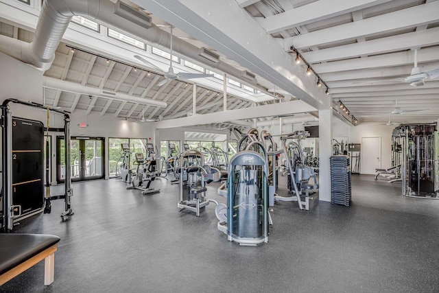 exercise room featuring high vaulted ceiling and ceiling fan