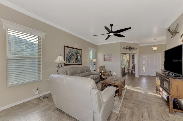 living room with ornamental molding, light parquet floors, and ceiling fan