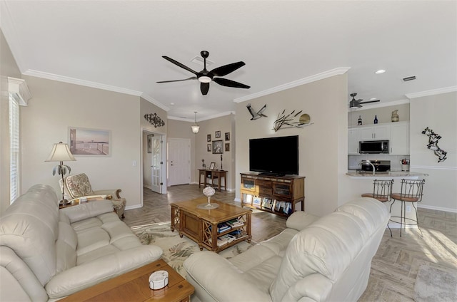 living room with ceiling fan, crown molding, and light parquet floors