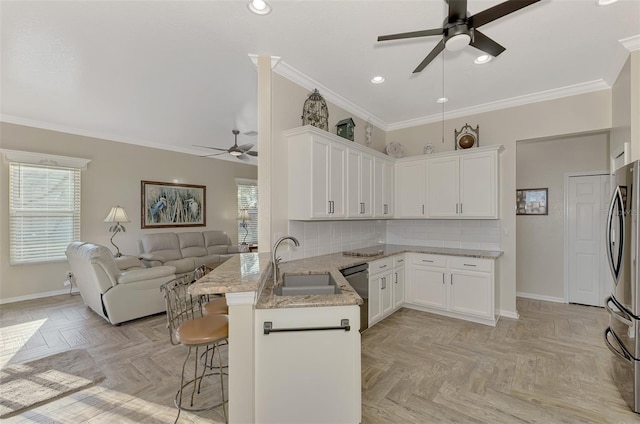 kitchen featuring a kitchen breakfast bar, white cabinetry, kitchen peninsula, and light parquet flooring