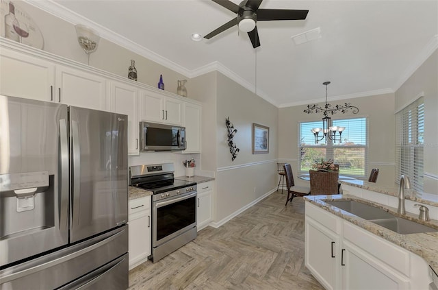 kitchen featuring sink, crown molding, white cabinets, appliances with stainless steel finishes, and light stone counters