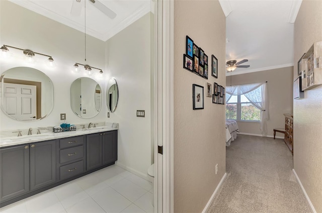 bathroom with toilet, ceiling fan, tile patterned floors, vanity, and ornamental molding