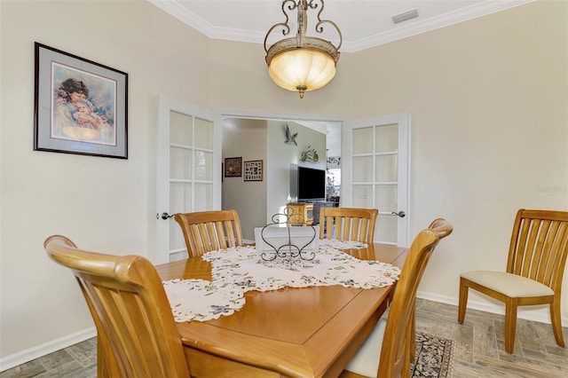 dining room featuring ornamental molding and hardwood / wood-style floors