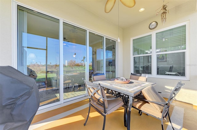 sunroom featuring ceiling fan