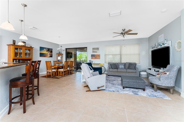 living room featuring light tile patterned floors and ceiling fan