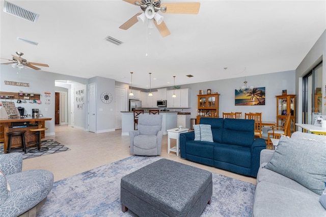 living room featuring ceiling fan and light tile patterned floors