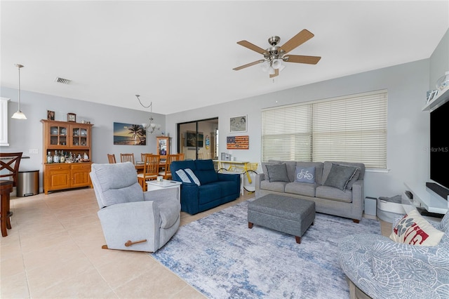 tiled living room with ceiling fan