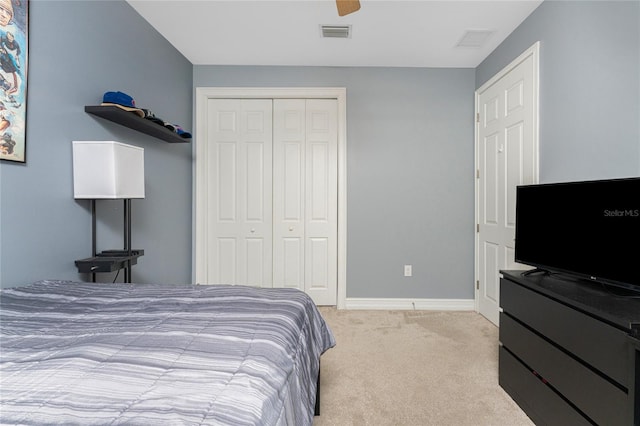 carpeted bedroom featuring ceiling fan and a closet