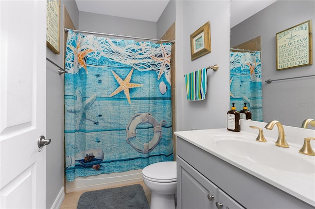 full bathroom featuring shower / bath combo with shower curtain, tile patterned flooring, vanity, and toilet