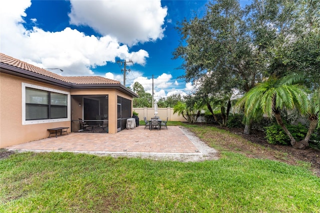 view of yard featuring a sunroom and a patio