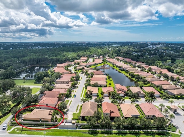 birds eye view of property with a water view