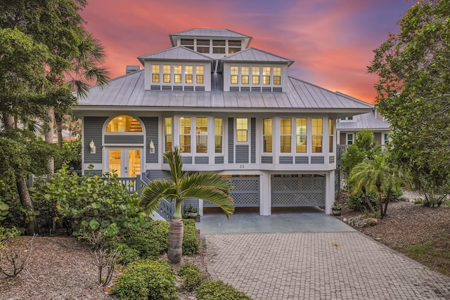 22 Seawatch Dr, Boca Grande, FL 33921 - beach home featuring french doors, driveway, a carport, a standing seam roof, and covered porch