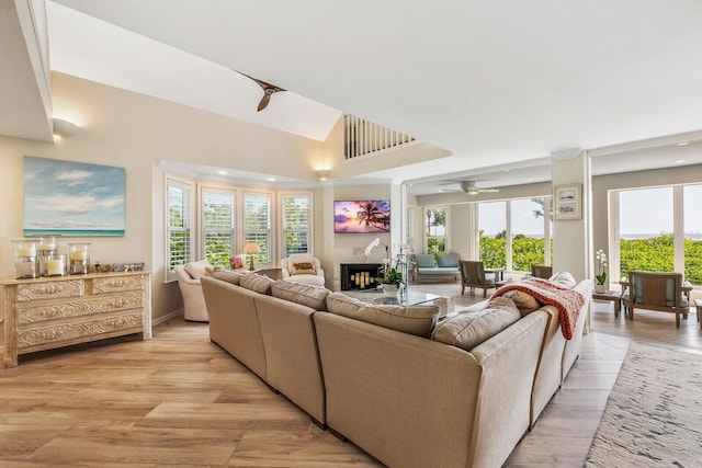 22 Seawatch Dr, Boca Grande, FL 33921 - living area with a premium fireplace, recessed lighting, healthy amount of natural light, light wood finished floors, and vaulted ceiling