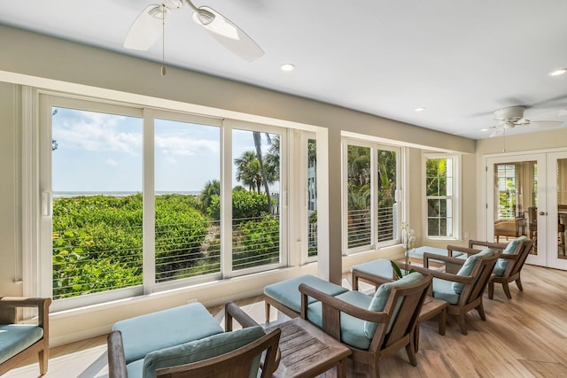 sunroom featuring ceiling fan and french doors