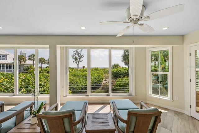 sunroom / solarium with plenty of natural light and ceiling fan