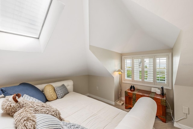 bedroom featuring vaulted ceiling with skylight